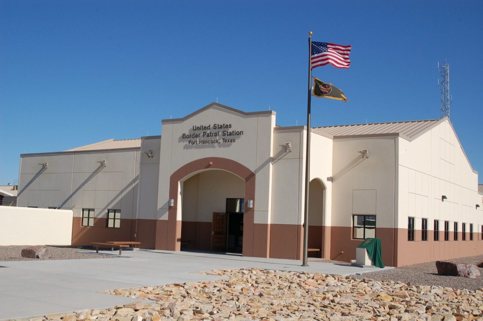 A building with an american flag flying in front of it.