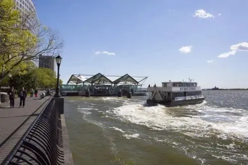 A ferry boat is going down the river.